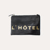 black leather clutch with l'hotel lettering